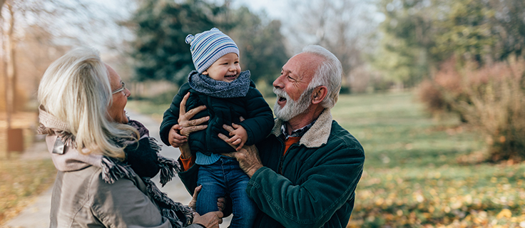 Grandparents play with a grandchild.