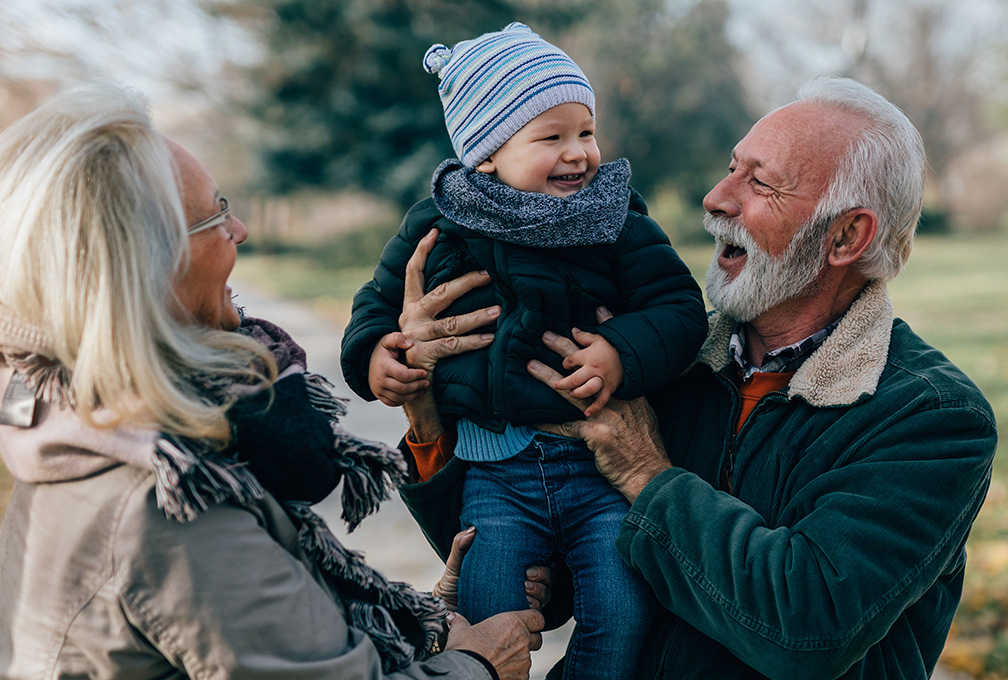 Grandparents play with a grandchild.