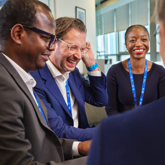 Group of staff laugh together.