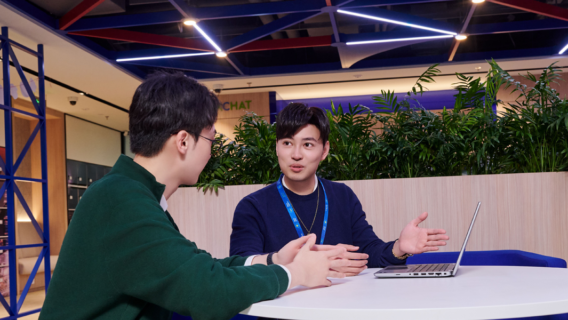 Colleagues talking round a table