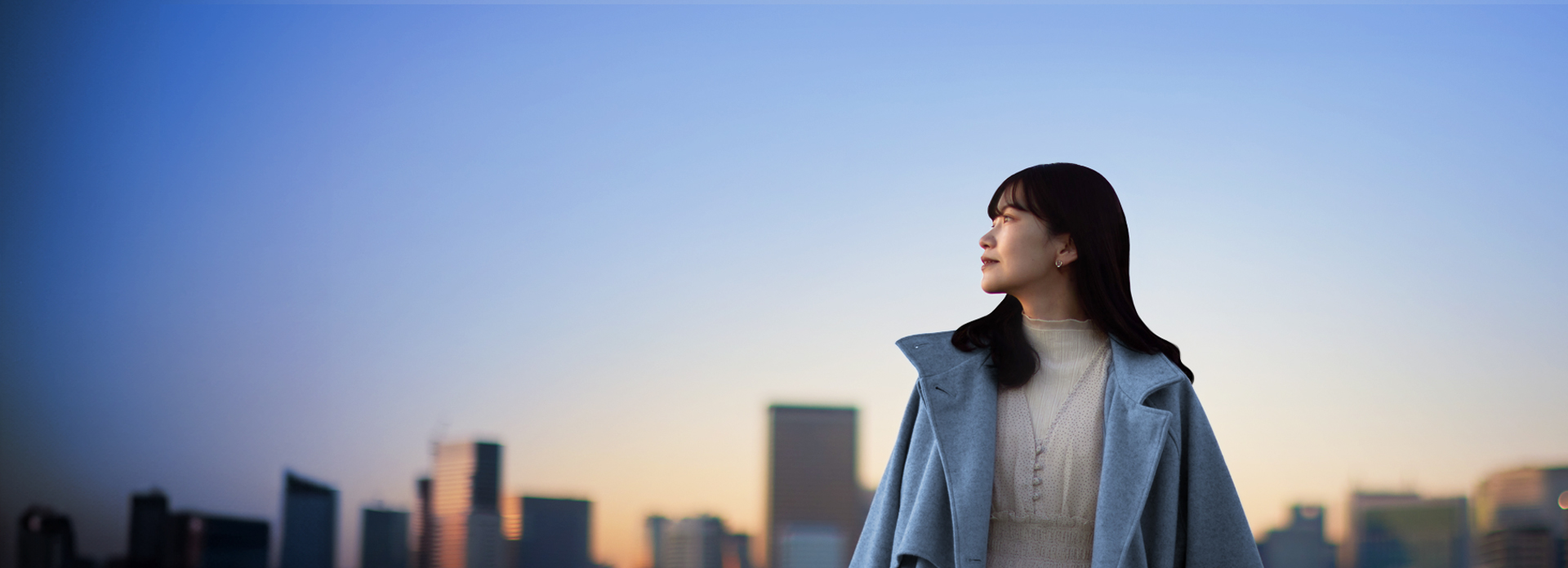 girl in front of city skyline