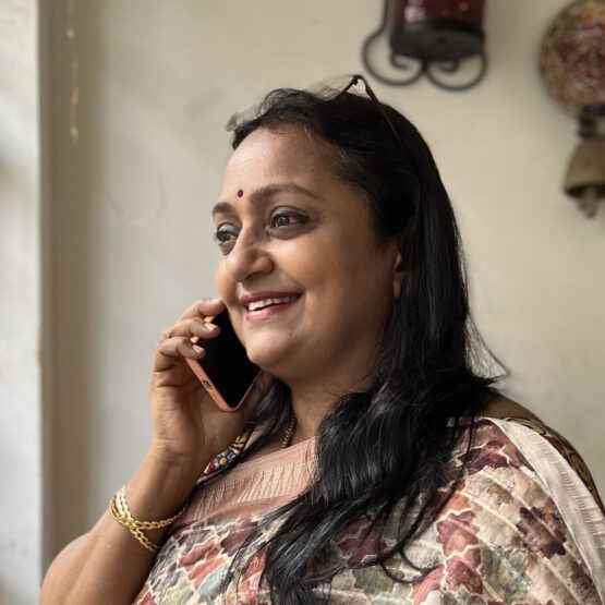 A woman in a saree, talking on the phone