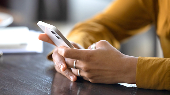 Someone using a phone on a table