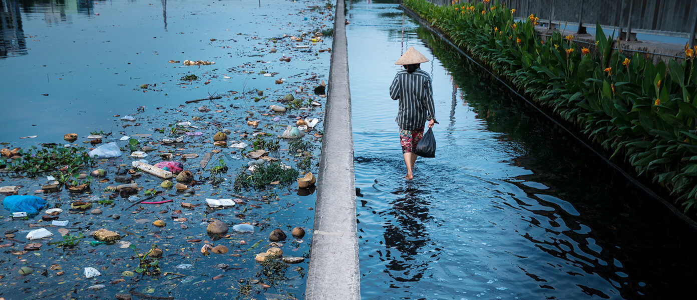 Man walks alongside plastic waste