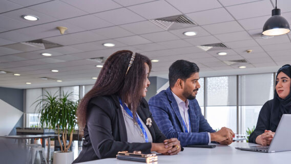 A group of Standard Chartered employees discuss our business model.