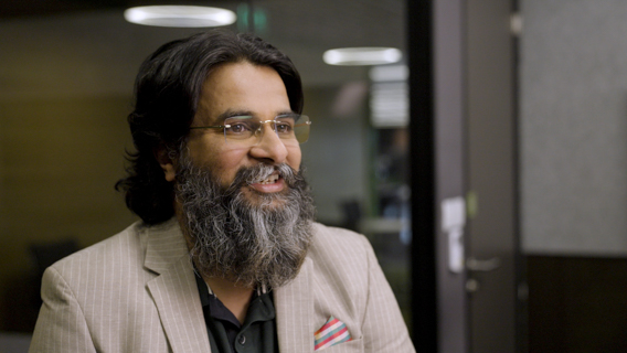 Man in suit and glasses smiling