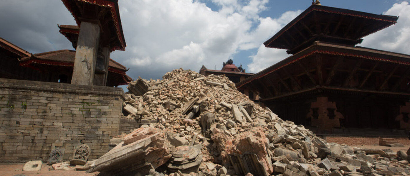 building with pile of broken rubble in the middle