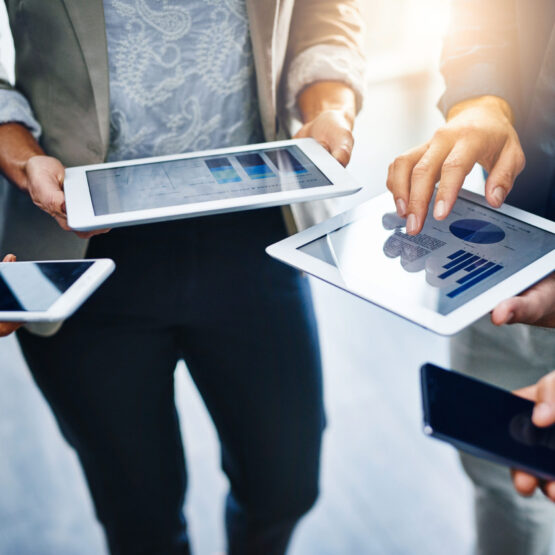 group of people using tablets and mobile phones to work