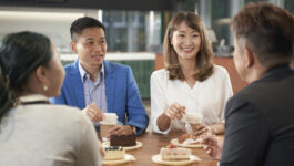 Colleagues having coffee in office
