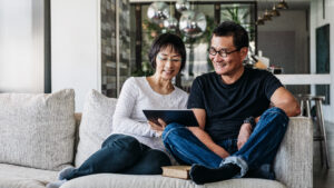 couple with tablet on a couch