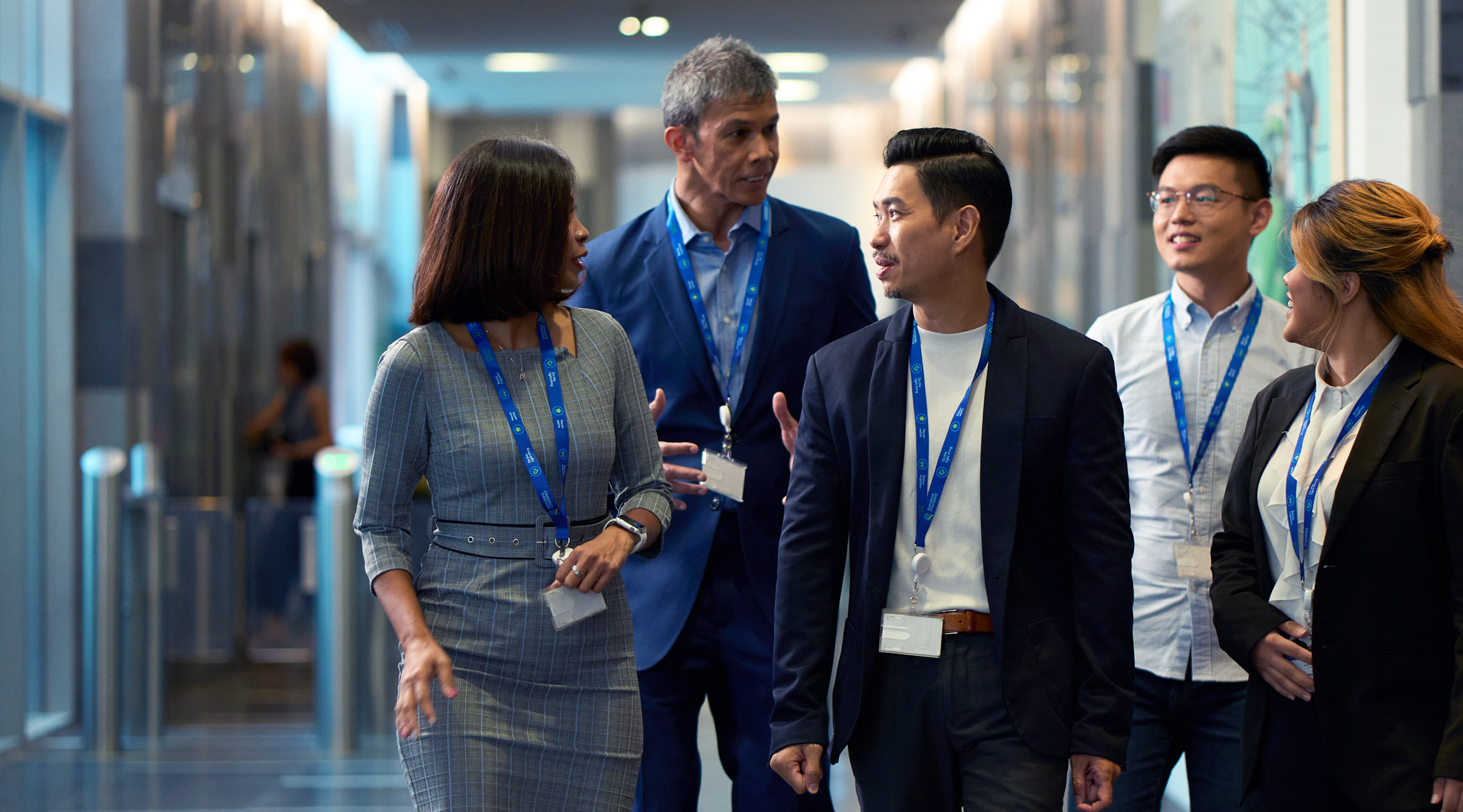 Colleagues walk together in a Standard Chartered office in Singapore.