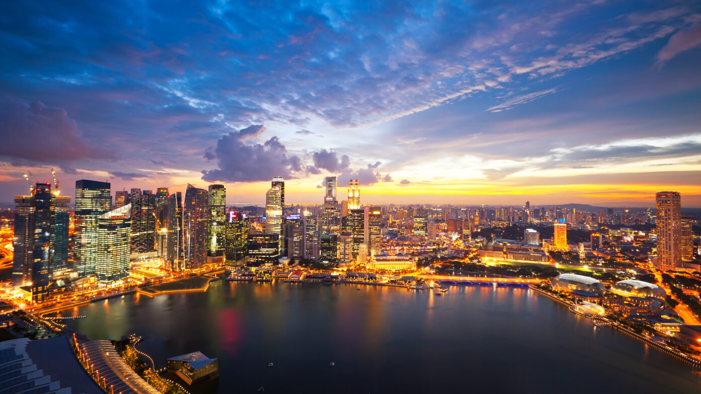 Aerial view of Marina Bay Skyline in Singapore at sunset.