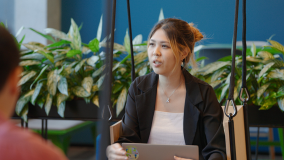 A person talking to a work colleague