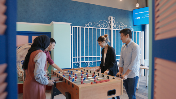 A group of people playing table top football 