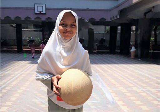 Young person holding a ball