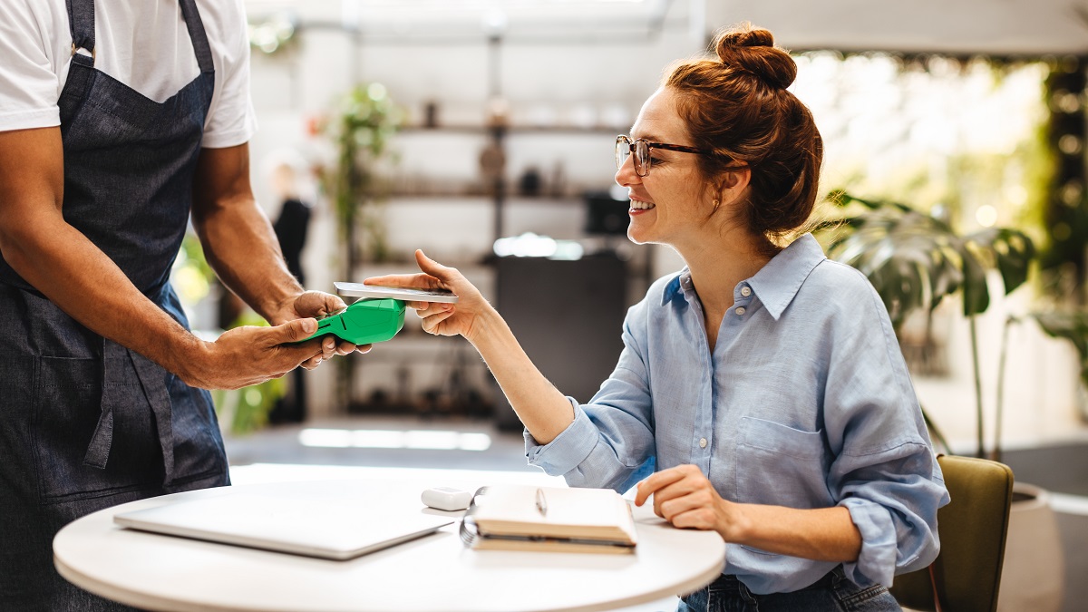 Female customer making contactless payment