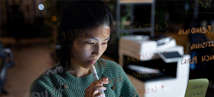 A woman works on a banking problem.