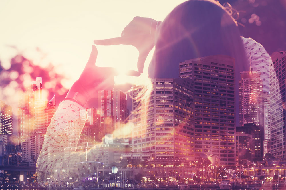 Double exposed image of girl and cityscape
