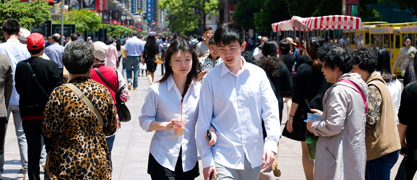 young couple walking through crowd