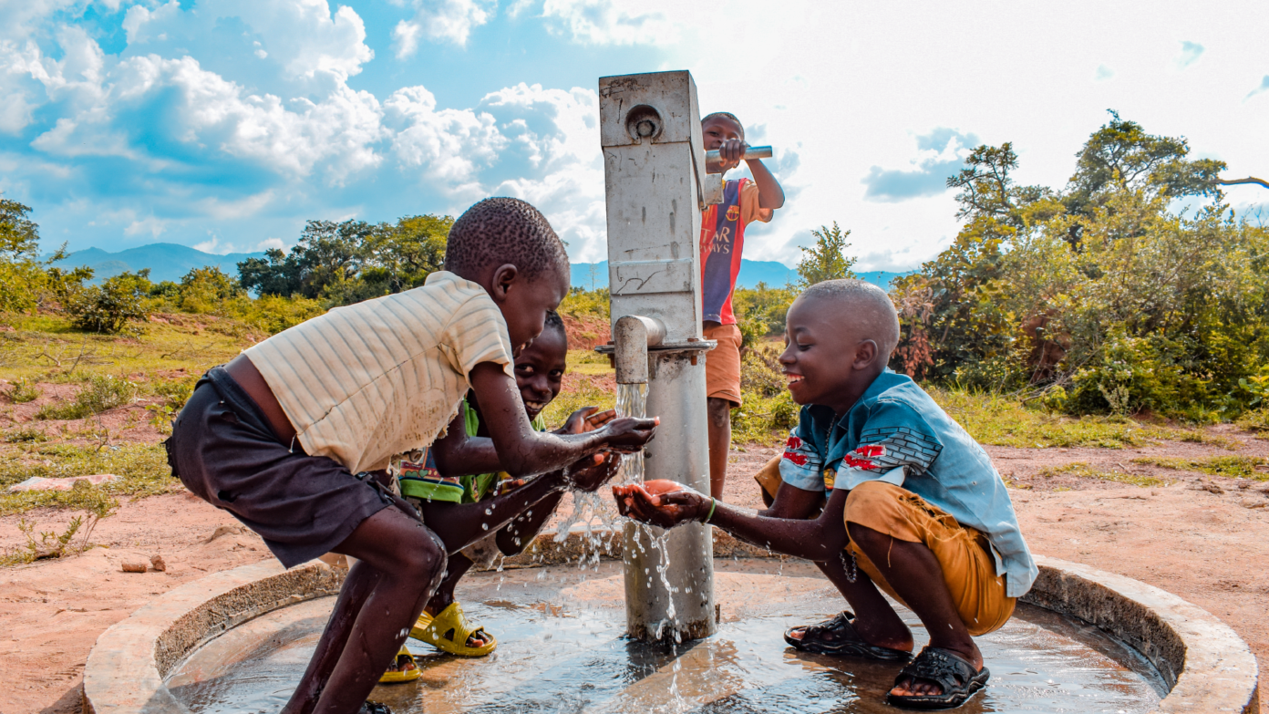 Children playing with water out of a borewell