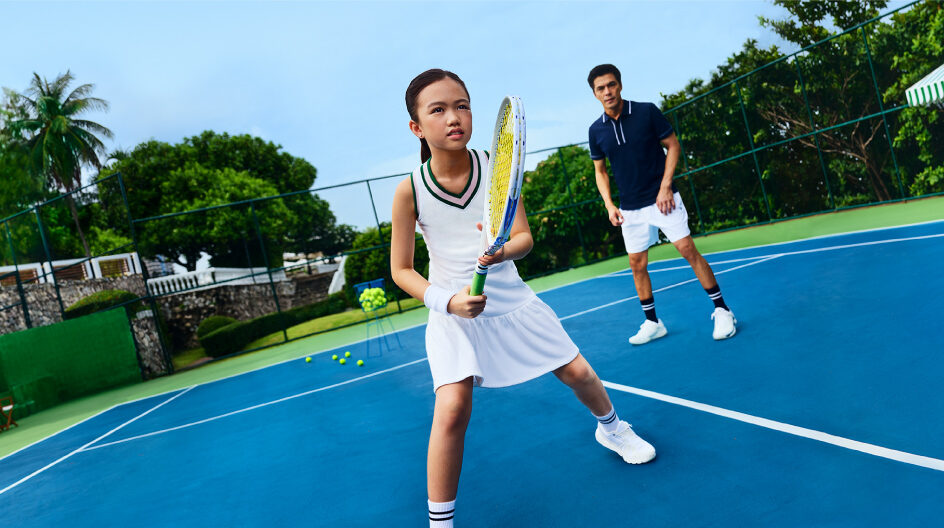 Two players engaged in a tennis match on a vibrant blue court