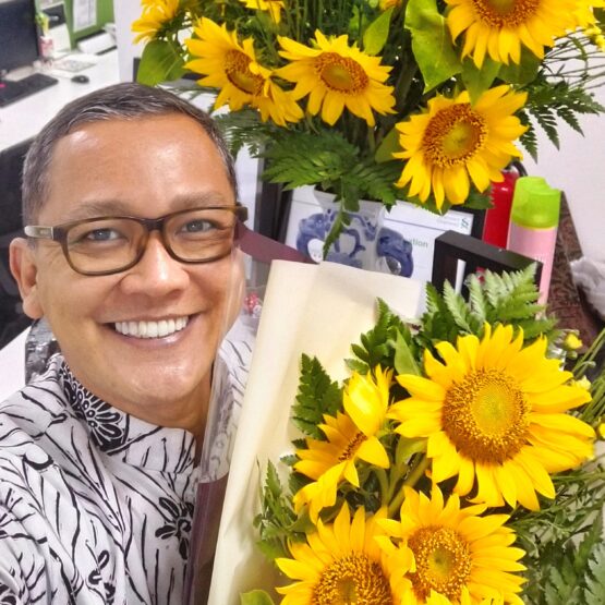 A man with sunflower bouquet
