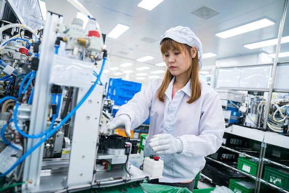 Lady operating machinery in a factory