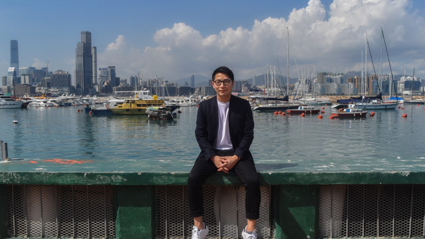 William Luk sitting in front of harbor