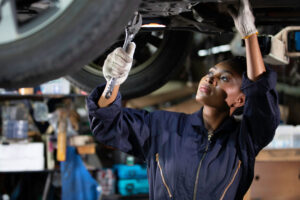 An engineer fixes a vehicle.