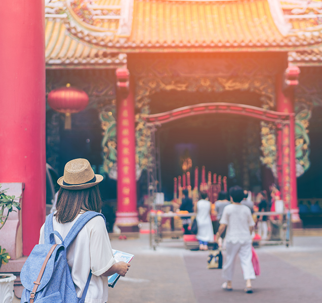 Woman looking the map with chinese temple background