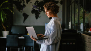 business women laptop with a world map in background