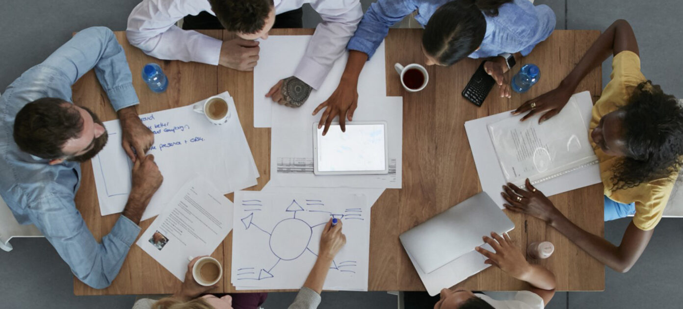 Top view of a table at work with colleagues and tab