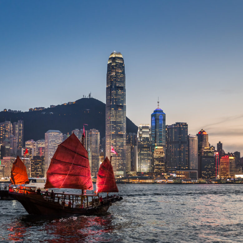 Traditional junk boat sailing across Victoria Harbour, Hong Kong.