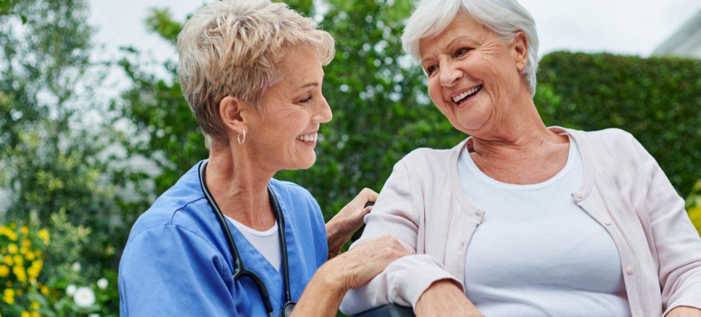 two women with short hair smiling