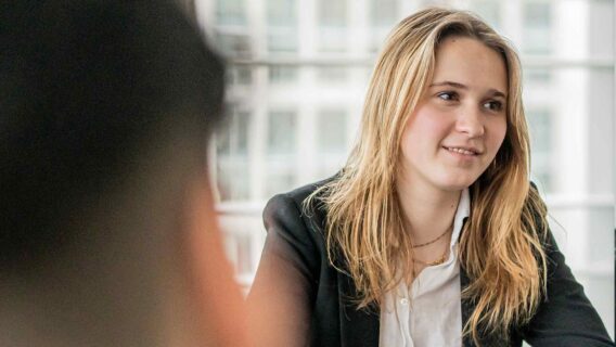 Blonde graduate listening