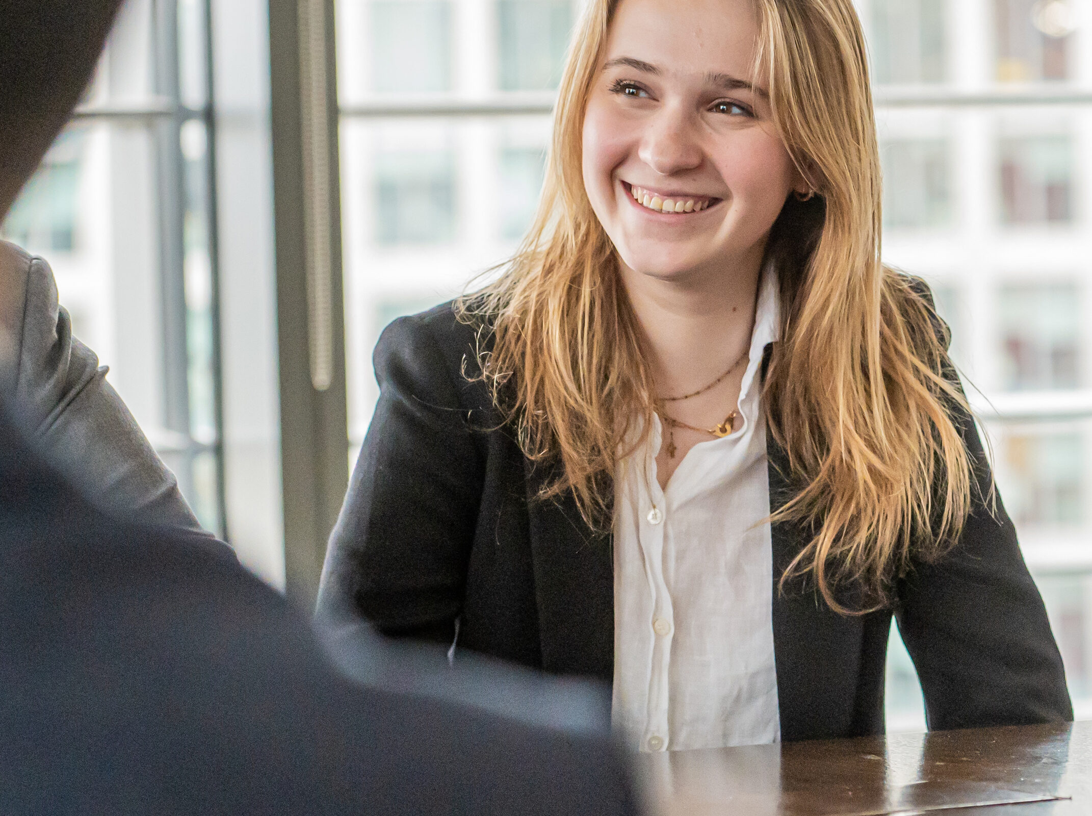 Lady smiling talking to colleagues