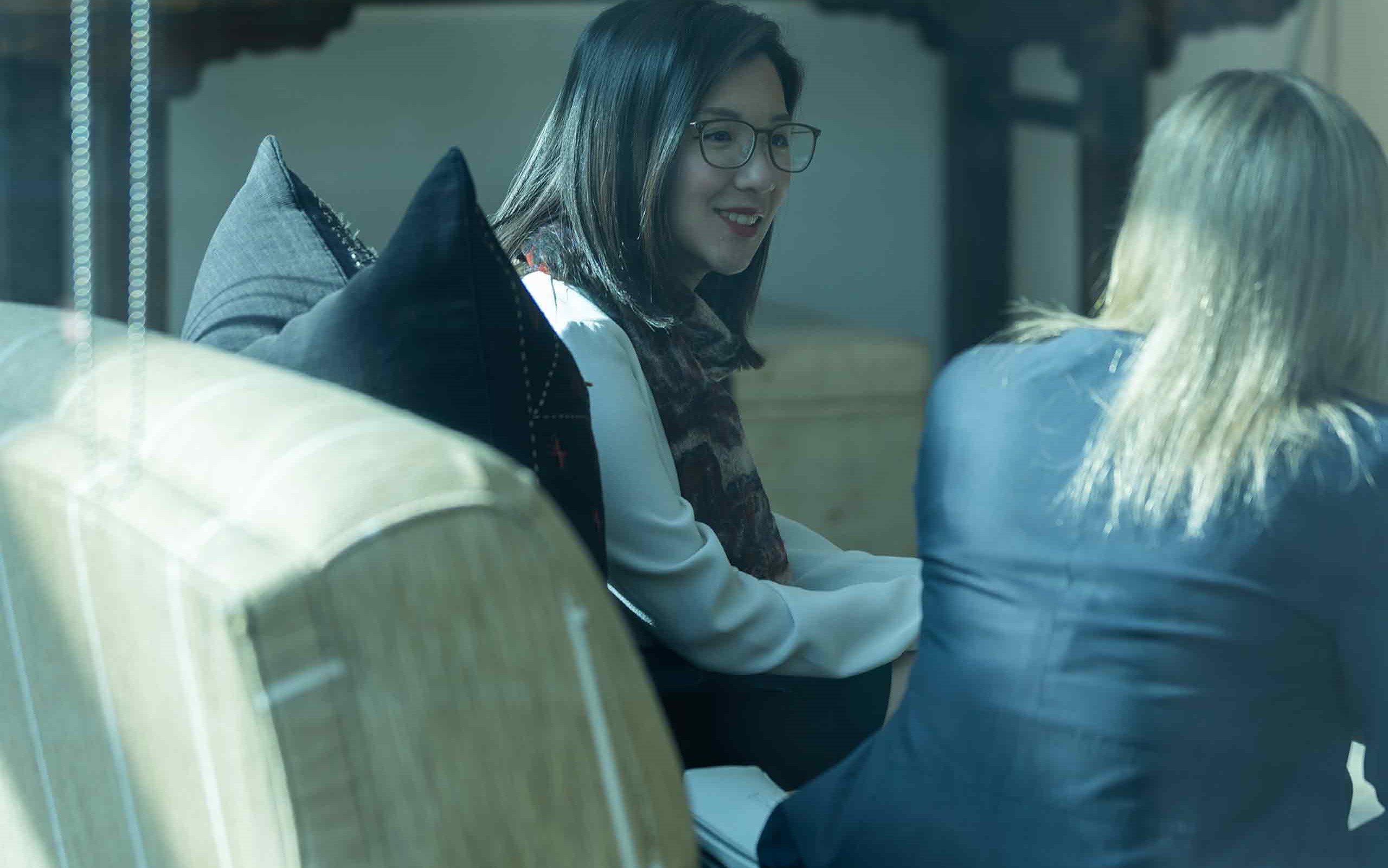 women talking on a sofa