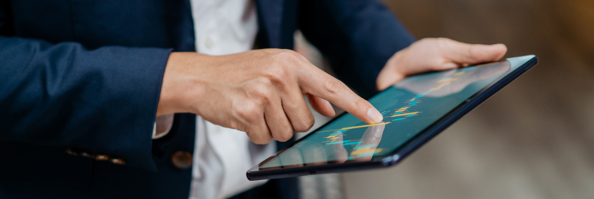 man with a tablet looking at charts