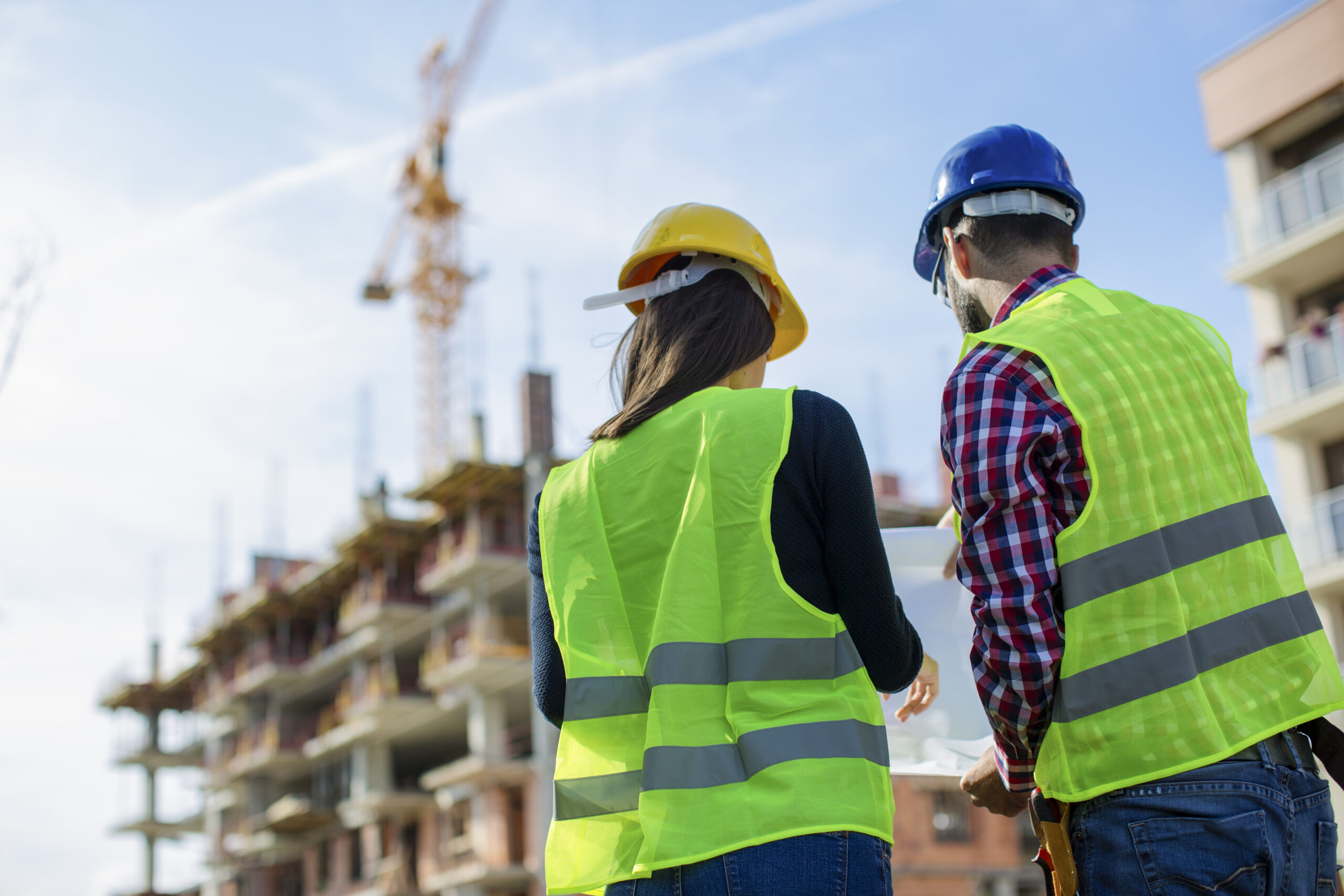 Two construction workers looking at the blueprint