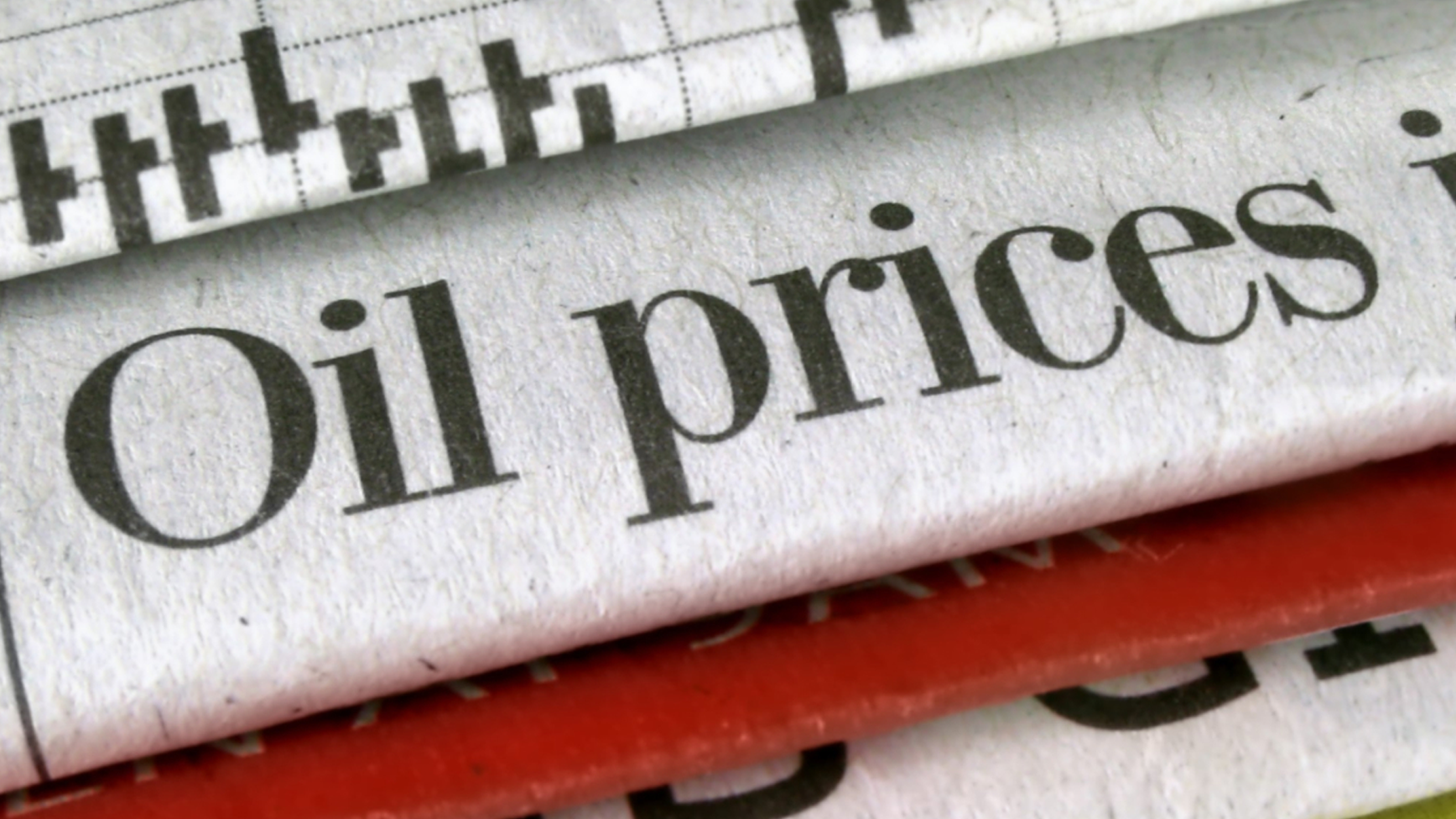 A newspaper shows a headline warning of oil price rises.