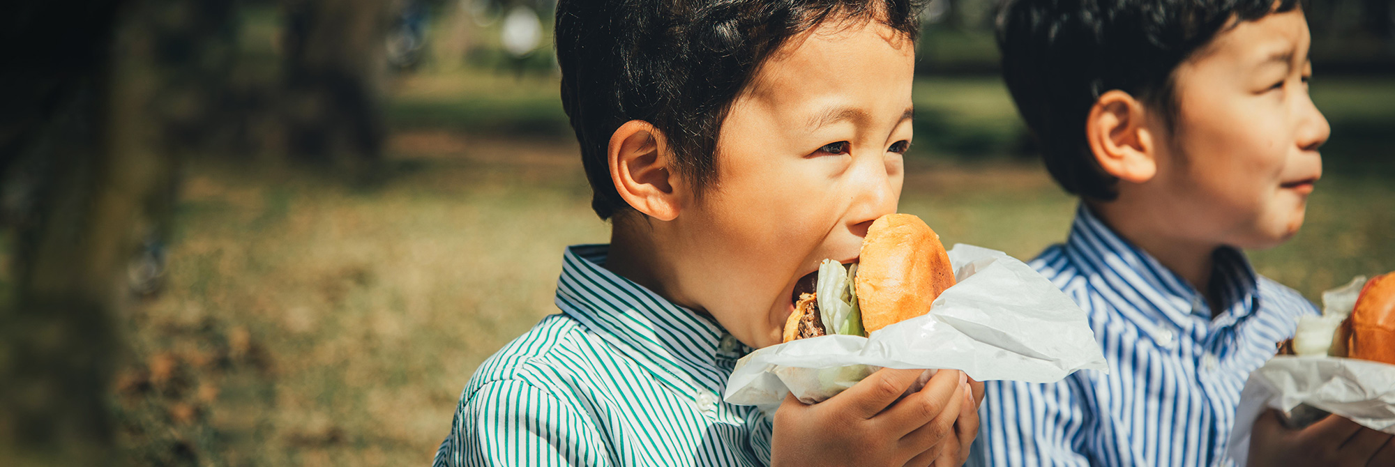 A child biting into a burger