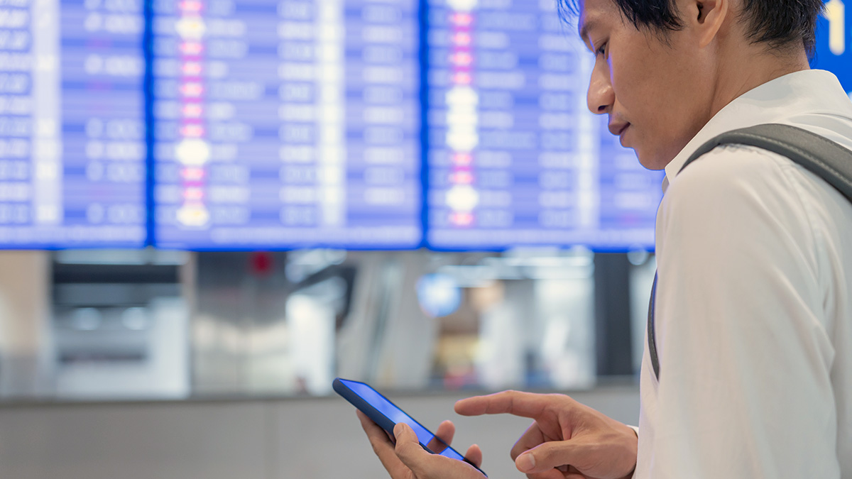 Man at airport looking at phone
