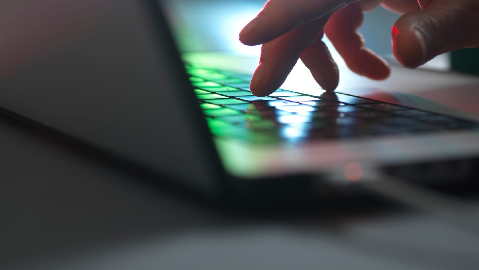 A person uses a laptop to set up AI-enabled financial crime controls.