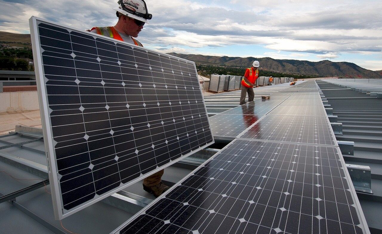 Workmen installing solar panels