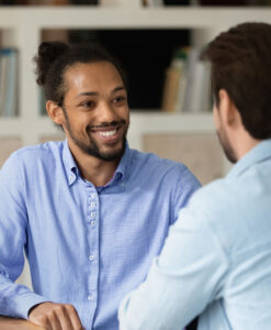 A young man in a blue shirt attends an interview.