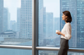 smiling person by a window