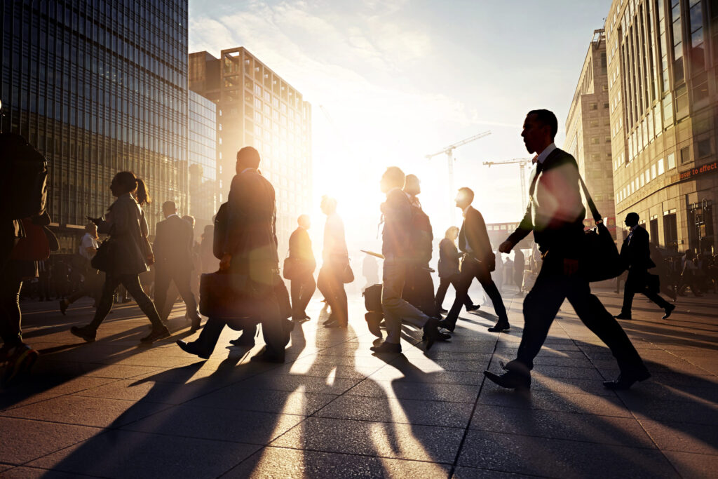 Employees walking to work in the city in sunrise