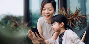 mother and daughter looking at phone