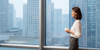 smiling person by a window