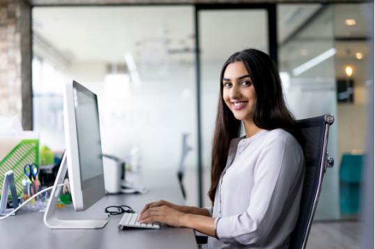 smiling worker at desk